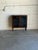 Sleek architectural form meets clean minimalist lines in this striking storage piece. Two tall glass doors swing outward...