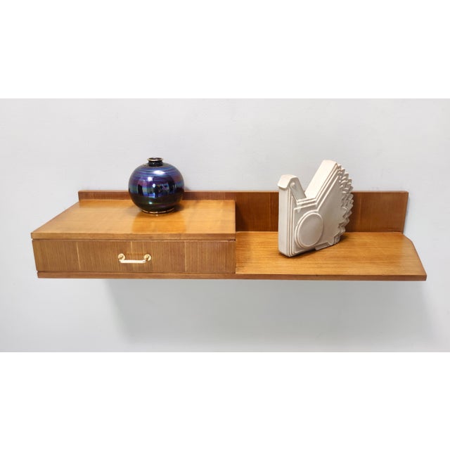 Made in Italy, 1950s. This beech and durmast wall-mounted console table features a brass handle. It might show slight...