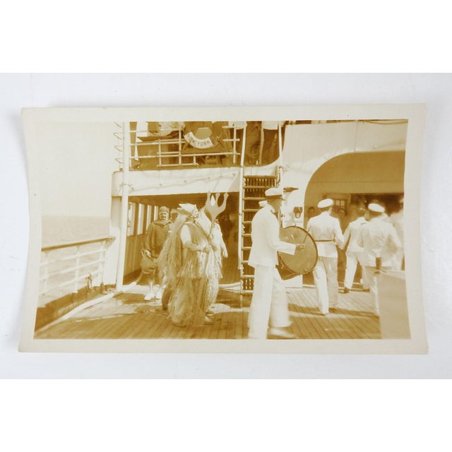 Early 20th century sepia tone snapshot photograph of a ships crew performing a King Neptune ceremony. The Navy's King...