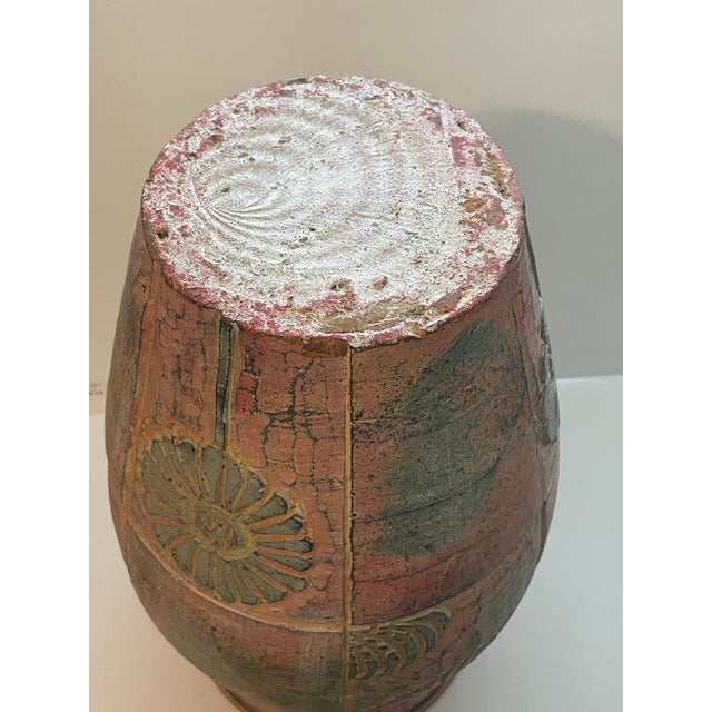 Pair of vintage incised terracotta floor vases with handles . The vases measure about 18” tall by 11” wide with a floral...