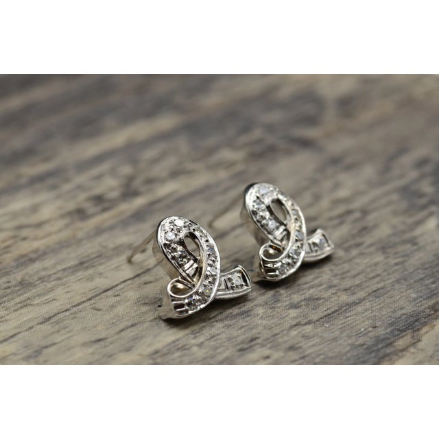 The Ribinas Antique Platinum and Diamond Ribbon Drop Earrings. Lightweight and comfortable to wear with standard posts,...