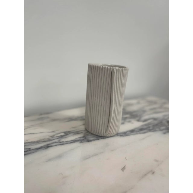 Cym Warkov’s dedication to pushing the boundaries of porcelain is evident in every curve and contour. The ribbed texture...