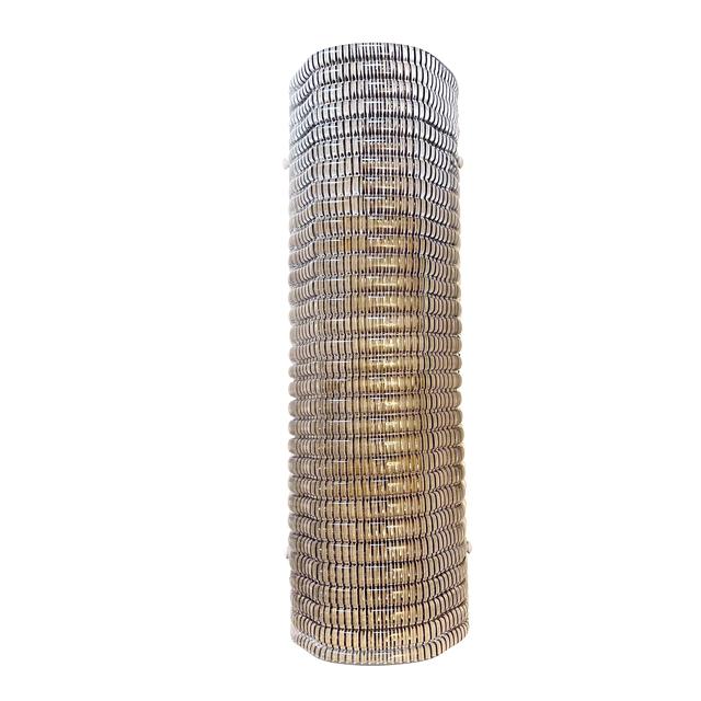 Contemporary wall sconce made in smoked Murano glass with a modern texture that give it bright . Made with a traditional...