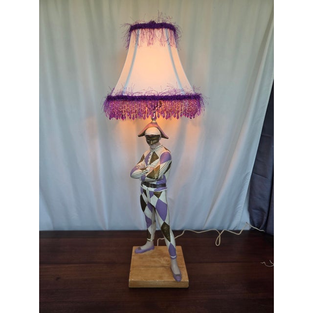 A striking and highly decorative vintage figural lamp featuring a classic harlequin / Commedia dell’Arte character,...