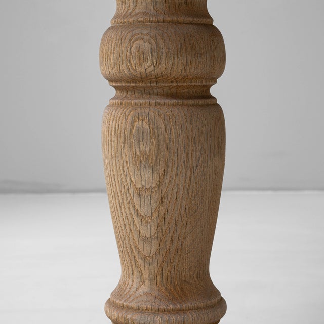 This 20th-century French oak dining table combines timeless craftsmanship with everyday functionality. Constructed from...