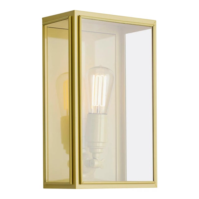 Wall light in brass lacquered in color with outside fitted clear or frosted glass and spring closure. For indoor and...