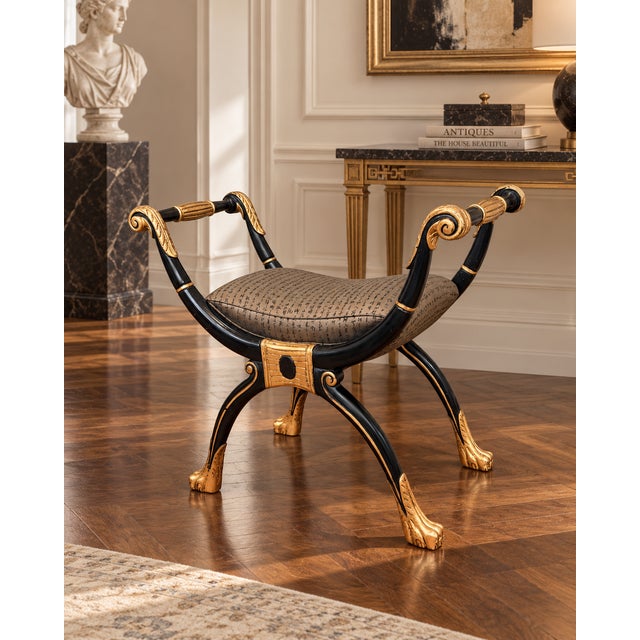 A striking vintage Maitland-Smith curule bench combining classical form with dramatic black-and-gilt detailing and Asian-...