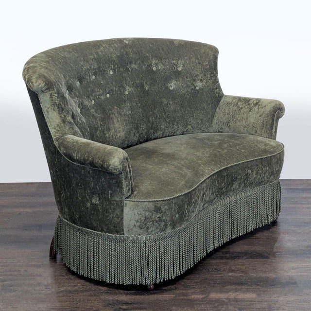 This vintage classic loveseat features a plush green velvet upholstery with a button-tufted backrest and rolled arms for...