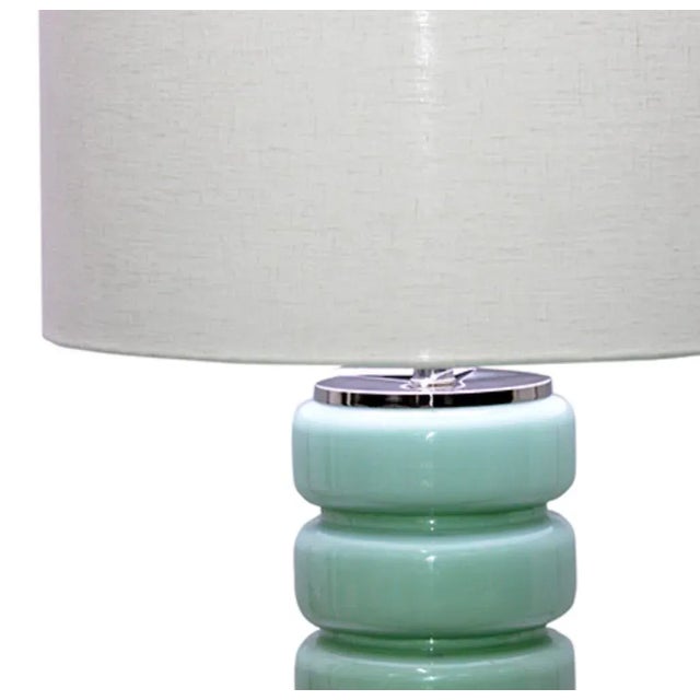 Mid-century style light turquoise glass table lamp with white linen shade. Base has clear bottom and chrome top. Lovely...