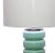 Mid-century style light turquoise glass table lamp with white linen shade. Base has clear bottom and chrome top. Lovely...