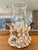 This handcrafted coastal hurricane candle holder is lavishly embellished with an organic collection of natural seashells...