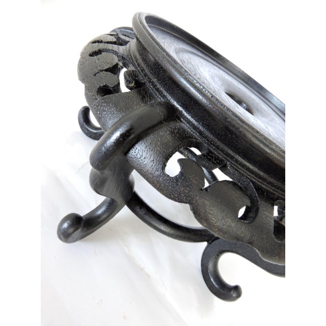 A circular solid dark brown rosewood stand for displaying a vase, carving or any of your treasures. Heavy well carved...