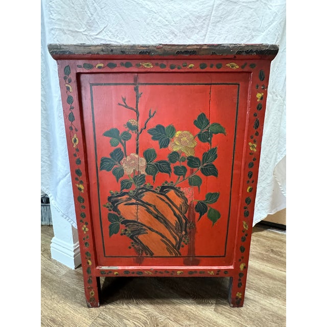 A striking Qing Dynasty Shanxi red lacquer wedding cabinet in elm, richly decorated with hand-painted figural landscape...