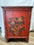 A striking Qing Dynasty Shanxi red lacquer wedding cabinet in elm, richly decorated with hand-painted figural landscape...