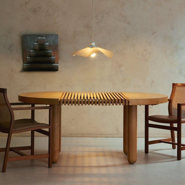 An Italian sculptural dining table of rare craftsmanship—at once architectural and deeply tactile. Thoughtfully conceived...