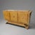 Modernist three door cabinet, France, 1940's. This striking design features a stylized lyre shaped side profile on a...