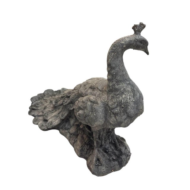 This striking vintage peacock statue is a testament to classic garden artistry, likely crafted from heavy cast iron or...