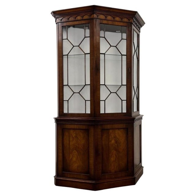 A handsome and unusually designed early 20th-century English display cabinet, finely constructed in mahogany and...