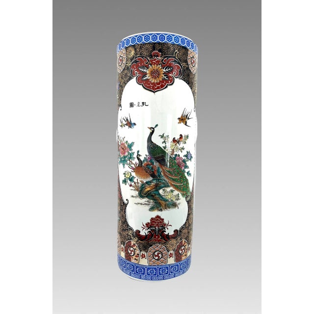 A larger than average Chinese export umbrella stand made from fine white porcelain, richly hand painted and decorated with...