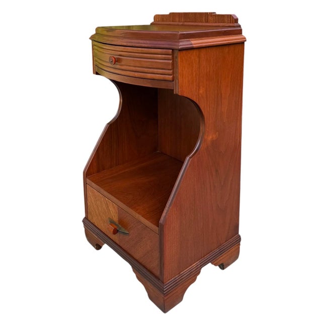 Striking vintage Art Deco nightstand featuring a sculptural silhouette, ribbed upper drawer front, and distinctive stepped...