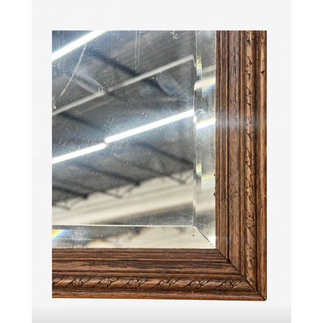 Small in scale. Very much not small in character. Sourced in France, this petite antique mirror dates to the late 19th...