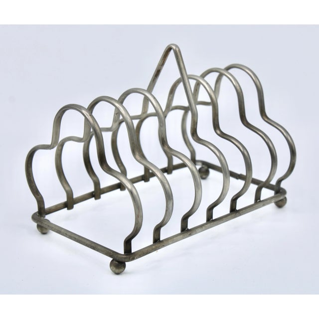 Fine quality English silver-plate toast rack. This charming 6 slice rack can also double to hold letters and mail as a...