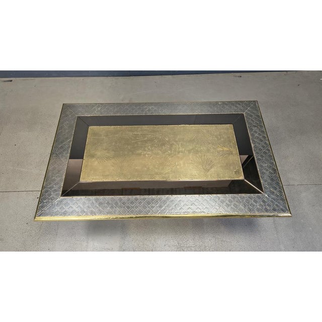 Impressive coffee table Signed by Gony Nava. The table is made of wood covered with hammered brass sheets and pewter...