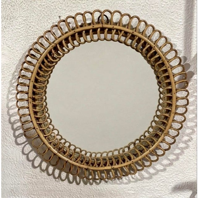 An elegant circular wall mirror, attributed to mid-century Italian design (inspired by the designs of Franco Albini and...