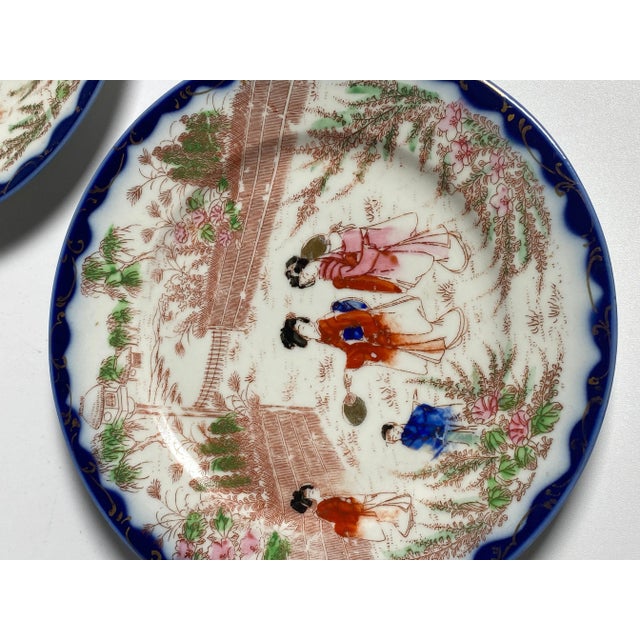 Pair of Japanese porcelain plates. The colors are blue, pink and green. They were made in Japan in the 19th century.
