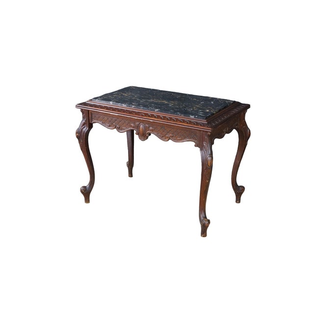 This vintage French Provincial Louis XV style coffee table or long side table features a rectangular silhouette...