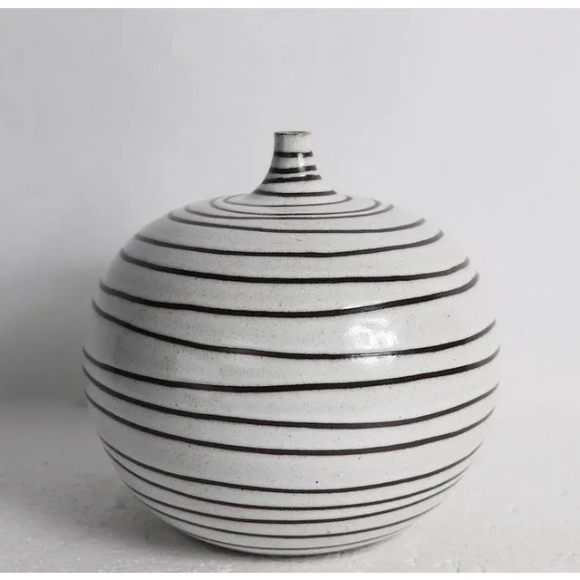 Chic pottery vase by noted potter Boyan Moskov, signed, and dated 2011. The vase has a sand color ground with sgraffito...