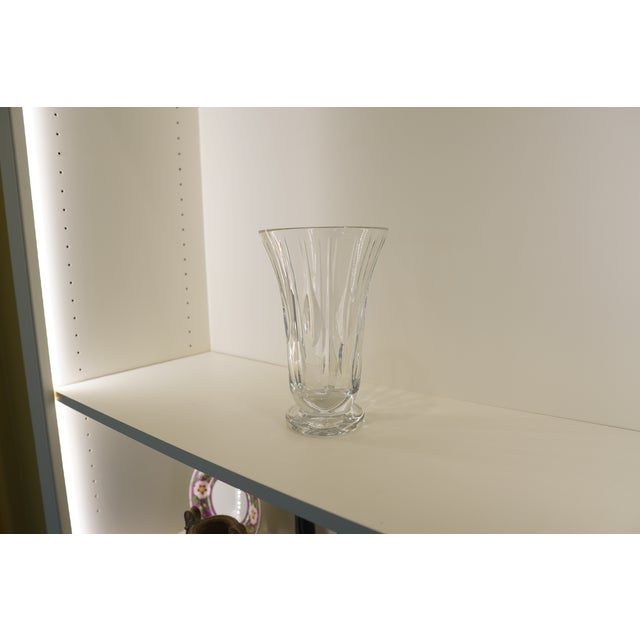 This elegant vintage crystal vase features a beautifully flared silhouette accented by elongated vertical cut-glass...