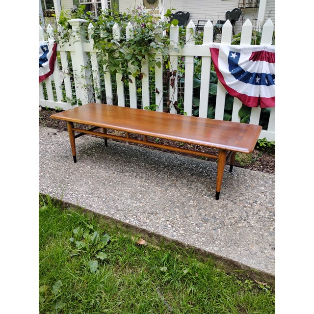 A Mid Century cocktail table in restored and refinished condition. This is from Lane Furniture's Acclaim collection....