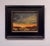 The painting depicts a dramatic marsh landscape at dusk, where vibrant oranges and yellows clash with deep grays and blues...