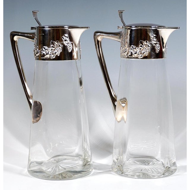 Two carafes made of clear glass with a conical body, the inner walls featuring a six-rayed, wavy thickening, a cut star on...