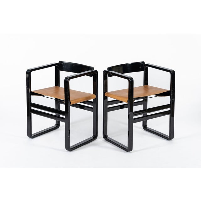 This unique pair of vintage mid century modern lacquer and leather sling lounge chairs in the style of Verner Panton are...