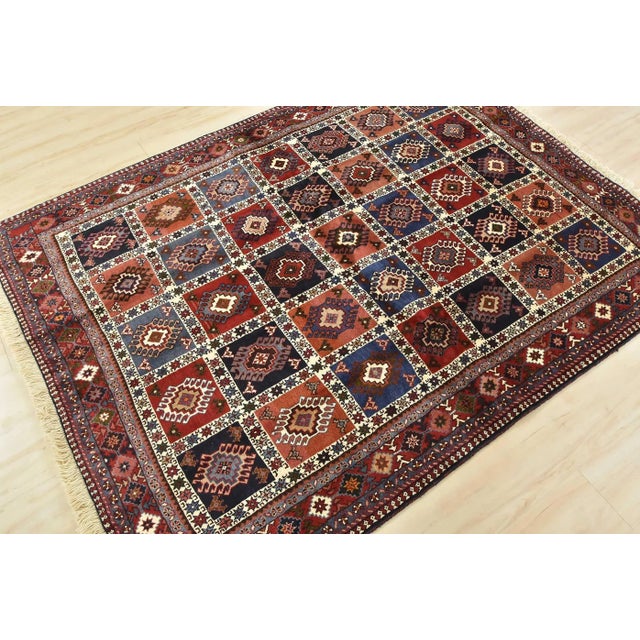 An authentic vintage tribal Yalameh rug hand-knotted with fine wool and natural dyes. This finely woven nomadic rug...