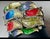 substantial, opulent cuff bracelets featuring multi-colored poured enamel, intricate cast openwork backs, and pave...
