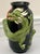 Striking sculptural ceramic vase featuring a bold green dragon in high relief, coiled around a glossy black body. The...