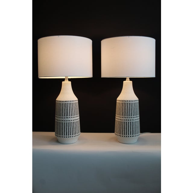 Pair of Gerald Thurston style lamps. Linen white textured finish with onyx embossed stripes. The two combinations give a...