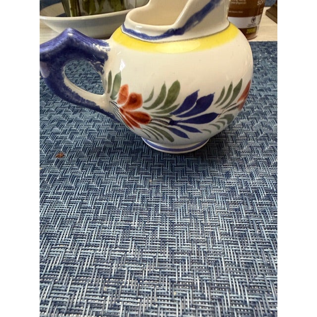 Quimper small creamer. Made in France in very good condition. See photos off white with blue and yellow, red and green