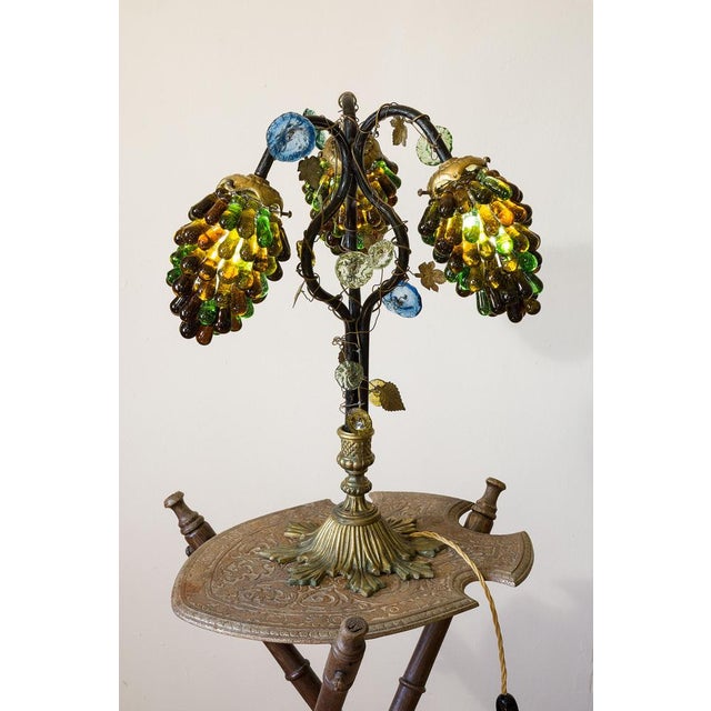 Art Nouveau lamp dating back to the early 1900s. Its structure consists of a finely handmade bronze base, combined with an...