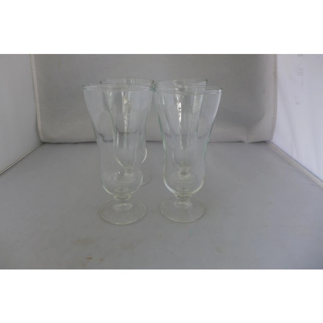 Mid century set of four clear glass parfait / soda glasses. No makers mark. In excellent condition. 2.75"D X 5.75"H X...