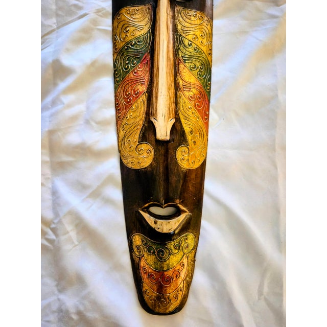 Up for sale is a stunning, large-scale 39.5-inch hand-carved Indonesian wooden wall mask. This statement piece features a...