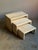 A set of three nesting side tables in solid travertine, designed in a stepped form typical of postmodern furniture. Each...