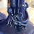 A deep blue pair of vases with a raised crawling dragon around the base of each neck. A perfect pair. 8.5" tall, base...
