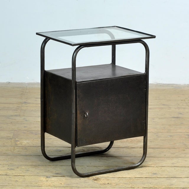 Iron nightstand with a glass top from circa 1920, originating from a hospital. The cabinet has been completely stripped of...