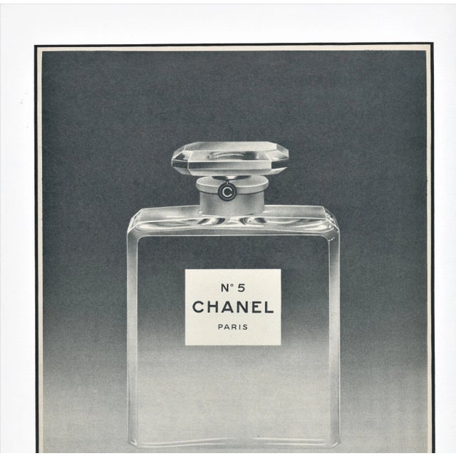 This is a matted French advertisement print for Chanel No.5 perfume. It originally appeared in a French magazine that...