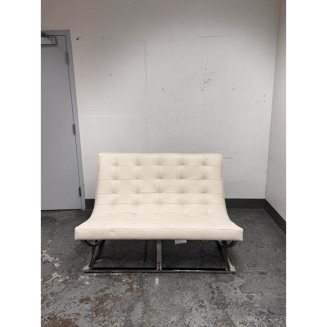Design Plus Gallery presents a James Loveseat from Williams-Sonoma. This compact loveseat has a tufted white leather with...