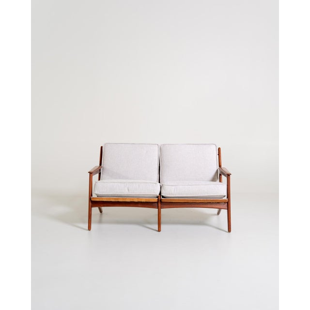 Danish teak sofa with removable cushions, recently reupholstered in light-colored fabric. Original marking: "Made in...